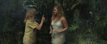 Movie still from “Snatched” (2017), directed by Jonathan Levine – A woman in a white dress talking to a man in a yellow shirt; Medium shot, Over the shoulder angle