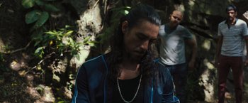 Movie still from “Snatched” (2017), directed by Jonathan Levine – A man with long black hair and a long beard; Medium shot, Over the shoulder angle