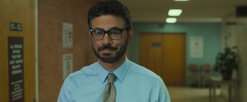 Movie still from “Snatched” (2017), directed by Jonathan Levine – A person wearing glasses and a tie; Close Up shot, Over the shoulder angle