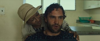 Movie still from “Snatched” (2017), directed by Jonathan Levine – A man with a beard and a woman with a hat on; Close Up shot, Over the shoulder angle
