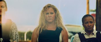 Movie still from “Snatched” (2017), directed by Jonathan Levine – A woman with long blonde hair wearing a black top; Close Up shot, Over the shoulder angle