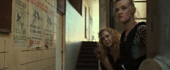 Movie still from “Snatched” (2017), directed by Jonathan Levine – Three women standing in a hallway next to a staircase; Medium shot, Over the shoulder angle