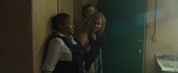Movie still from “Snatched” (2017), directed by Jonathan Levine – A group of women standing next to each other in a room; Medium shot, Over the shoulder angle