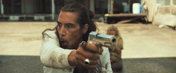 Movie still from “Snatched” (2017), directed by Jonathan Levine – A man holding a gun in front of a woman; Close Up shot, Over the shoulder angle