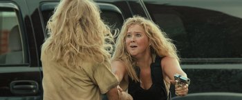 Movie still from “Snatched” (2017), directed by Jonathan Levine – A woman with long blonde curly hair is talking to another woman; Close Up shot, Over the shoulder angle