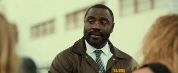 Movie still from “Snatched” (2017), directed by Jonathan Levine – A man wearing a brown jacket and a tie; Close Up shot, Low angle