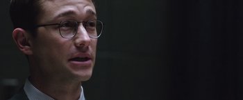 Movie still from “Snowden” (2016), directed by Oliver Stone – A person wearing glasses; Close Up shot, Over the shoulder angle
