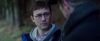 Movie still from “Snowden” (2016), directed by Oliver Stone – A young man wearing glasses and a sweater; Close Up shot, Over the shoulder angle