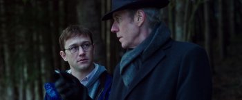 Movie still from “Snowden” (2016), directed by Oliver Stone – A man in a hat and glasses and another man in a coat and hat; Close Up shot, Over the shoulder angle