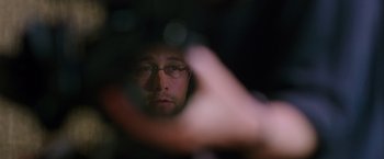 Movie still from “Snowden” (2016), directed by Oliver Stone – A man with glasses is looking at the camera; Extreme Close Up shot, Overhead angle