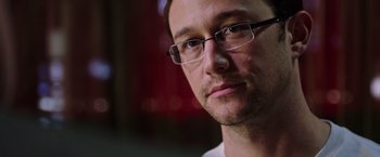 Movie still from “Snowden” (2016), directed by Oliver Stone – A person wearing glasses; Close Up shot, Low angle