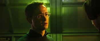 Movie still from “Snowden” (2016), directed by Oliver Stone – A person wearing glasses; Close Up shot, Low angle