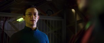 Movie still from “Snowden” (2016), directed by Oliver Stone – A man wearing glasses and a blue sweater; Close Up shot, Over the shoulder angle