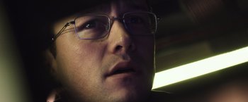 Movie still from “Snowden” (2016), directed by Oliver Stone – A person wearing glasses; Close Up shot, Low angle