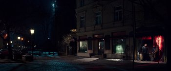 Movie still from “Snowden” (2016), directed by Oliver Stone – A building that is lit up at night time; Extreme Wide shot, High angle