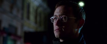 Movie still from “Snowden” (2016), directed by Oliver Stone – A person wearing glasses; Close Up shot, Over the shoulder angle