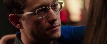 Movie still from “Snowden” (2016), directed by Oliver Stone – A person wearing glasses; Close Up shot, Over the shoulder angle