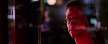 Movie still from “Snowden” (2016), directed by Oliver Stone – A person wearing glasses; Close Up shot, Over the shoulder angle