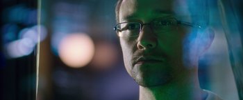 Movie still from “Snowden” (2016), directed by Oliver Stone – A person wearing glasses; Extreme Close Up shot, Over the shoulder angle