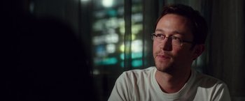 Movie still from “Snowden” (2016), directed by Oliver Stone – A person wearing glasses and a white shirt; Close Up shot, Over the shoulder angle