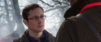 Movie still from “Snowden” (2016), directed by Oliver Stone – A man wearing glasses talking to another man; Close Up shot, Over the shoulder angle