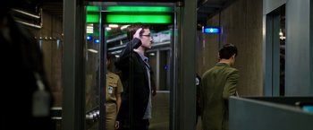 Movie still from “Snowden” (2016), directed by Oliver Stone – A man is talking on a cell phone while standing in an elevator; Medium shot, Low angle