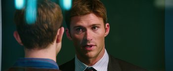 Movie still from “Snowden” (2016), directed by Oliver Stone – A person wearing a suit and tie; Close Up shot, Over the shoulder angle