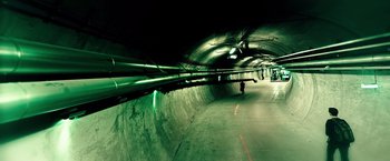 Movie still from “Snowden” (2016), directed by Oliver Stone – A man riding a skateboard down a ramp; Extreme Wide shot, High angle