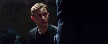 Movie still from “Snowden” (2016), directed by Oliver Stone – A man in a black jacket is looking at a man in a black suit; Close Up shot, Over the shoulder angle