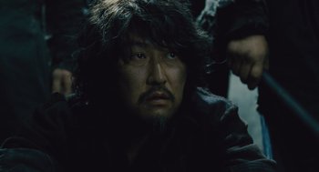 Movie still from “Snowpiercer” (2013), directed by Bong Joon Ho – A person wearing a fur coat; Close Up shot, Over the shoulder angle