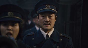 Movie still from “Snowpiercer” (2013), directed by Bong Joon Ho – A man wearing a uniform and a hat; Close Up shot, Low angle