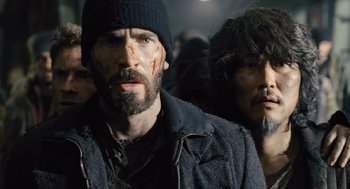 Movie still from “Snowpiercer” (2013), directed by Bong Joon Ho – A man in a black jacket and a man in a black hat; Close Up shot, Low angle