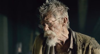 Movie still from “Snowpiercer” (2013), directed by Bong Joon Ho – An old man with a long beard wearing glasses; Close Up shot, Low angle