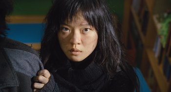 Movie still from “Snowpiercer” (2013), directed by Bong Joon Ho – A person wearing a sweater; Close Up shot, Low angle