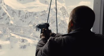 Movie still from “Snowpiercer” (2013), directed by Bong Joon Ho – A man holding a camera up to the side of a ski lift; Medium shot, Low angle