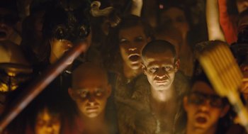 Movie still from “Snowpiercer” (2013), directed by Bong Joon Ho – A group of people that are standing in the dark; Medium shot, Low angle