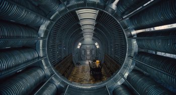 Movie still from “Snowpiercer” (2013), directed by Bong Joon Ho – A room that has a table and chairs inside of it; Wide shot, Overhead angle