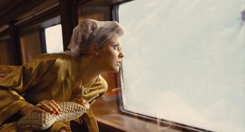 Movie still from “Snowpiercer” (2013), directed by Bong Joon Ho – A woman looking out of a window on a train; Medium shot, Low angle