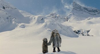 Movie still from “Snowpiercer” (2013), directed by Bong Joon Ho – A person holding hands with a dog in the snow; Wide shot, Low angle