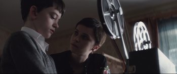 Movie still from “A Monster Calls” (2016), directed by J.A. Bayona – A young boy and a girl looking in a mirror; Close Up shot, Over the shoulder angle