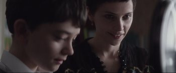 Movie still from “A Monster Calls” (2016), directed by J.A. Bayona – A woman sitting next to a young boy in front of a mirror; Close Up shot, Over the shoulder angle