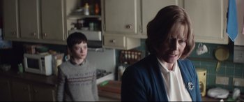 Movie still from “A Monster Calls” (2016), directed by J.A. Bayona – A woman and a boy standing in a kitchen; Medium shot, Over the shoulder angle