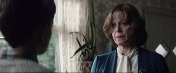 Movie still from “A Monster Calls” (2016), directed by J.A. Bayona – An older woman standing in front of a window; Close Up shot, Over the shoulder angle