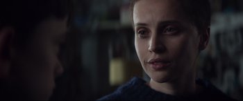 Movie still from “A Monster Calls” (2016), directed by J.A. Bayona – A woman's face in a dark room; Close Up shot, Over the shoulder angle