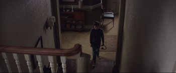 Movie still from “A Monster Calls” (2016), directed by J.A. Bayona – A young boy walking down the hall way of a house; Wide shot, High angle