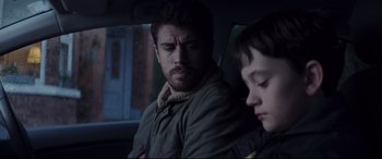Movie still from “A Monster Calls” (2016), directed by J.A. Bayona – A man and a boy sitting in the back of a car; Close Up shot, Over the shoulder angle