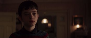 Movie still from “A Monster Calls” (2016), directed by J.A. Bayona – A young boy is looking into the camera; Close Up shot, Over the shoulder angle