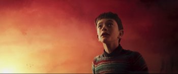 Movie still from “A Monster Calls” (2016), directed by J.A. Bayona – A boy in a striped sweater looking up at the sky; Medium shot, Low angle