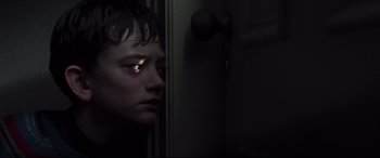 Movie still from “A Monster Calls” (2016), directed by J.A. Bayona – A young boy staring out of a dark room at night; Close Up shot, High angle