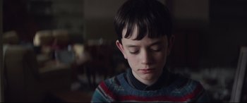 Movie still from “A Monster Calls” (2016), directed by J.A. Bayona – A young boy is looking down at his face; Close Up shot, Over the shoulder angle